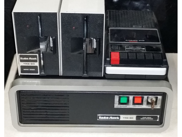Tandy-RadioShackのストレージいろいろ

　Tandy-RadioShackの「TRS-80」にはさまざまなストレージ装置が用意されていた。写真左上はデュアルフロッピーディスク装置、右上はカセットテープ装置、下は当時高根の花だった5メガバイトのハードディスクだ。