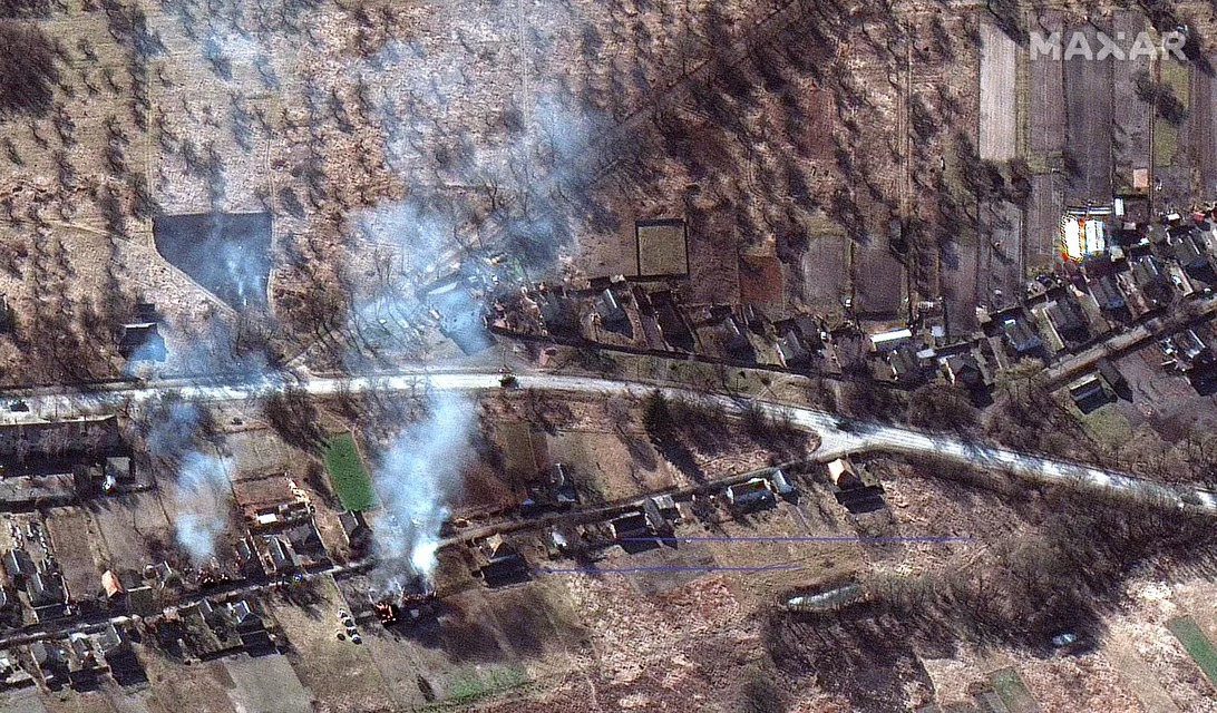 This satellite image from Maxar shows homes burning and part of a Russian convoy near Invankiv in Ukraine.
